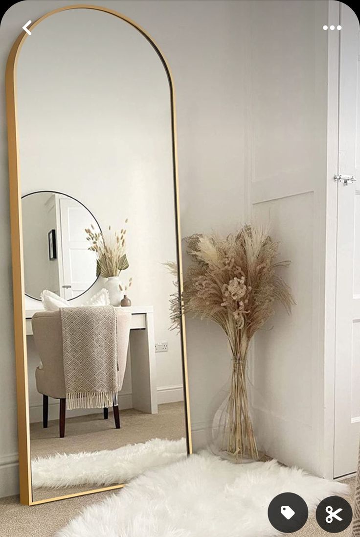 a large mirror sitting on top of a white rug