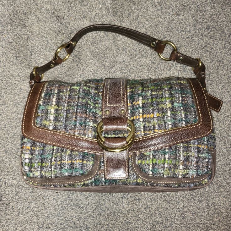 A Coach Chelsea Boucle Field Bag In Tweed, Leather And Suede In Earth Tones And Chocolate Brown Leather Trimmed In Metallic Bronze With Gold Tone Hardware, Flap Front With Magnetic Snap Closure, Signature Embossed Leather Chain Tag, Adjustable Strap, Two Pockets In Front With A Single Back Pocket, Chartreuse Sateen Interior With Divided Side Pockets, A Side Zipper Pocket With Embossed Leather Signature Tag # D05k-8f18. New With Tags, Dust Cover, Tags And Dated To 2005. Still Has Stuffing Inside. Coach Shoulder Bag For Fall Shopping, Office Bags With Leather Trim For Fall, Coach Bags With Leather Trim For Fall, Coach Bag With Leather Trim For Fall, Coach Shoulder Bag With Leather Handles For Fall, Tweed Bag With Detachable Strap, Rectangular Shape, Rectangular Tweed Bag With Detachable Strap, Field Bag, Dust Cover