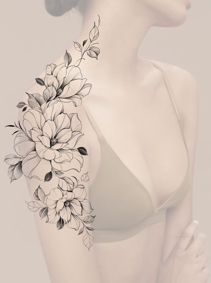 a woman wearing a bra with flowers on her arm and shoulder tattoo design in black and white