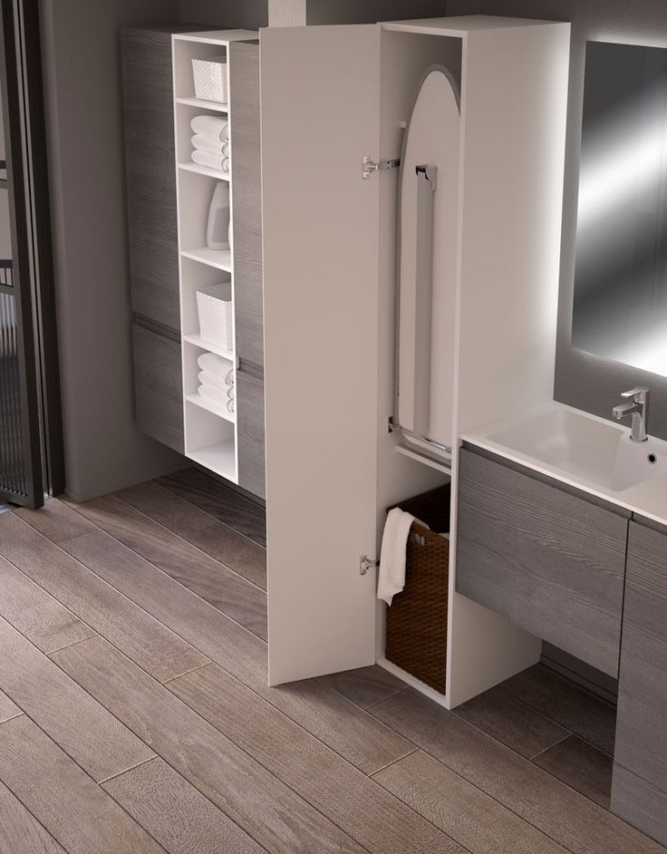 a bathroom with a sink, mirror and cabinet in it's center area is shown