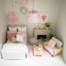 a doll house bedroom with pink and white decor