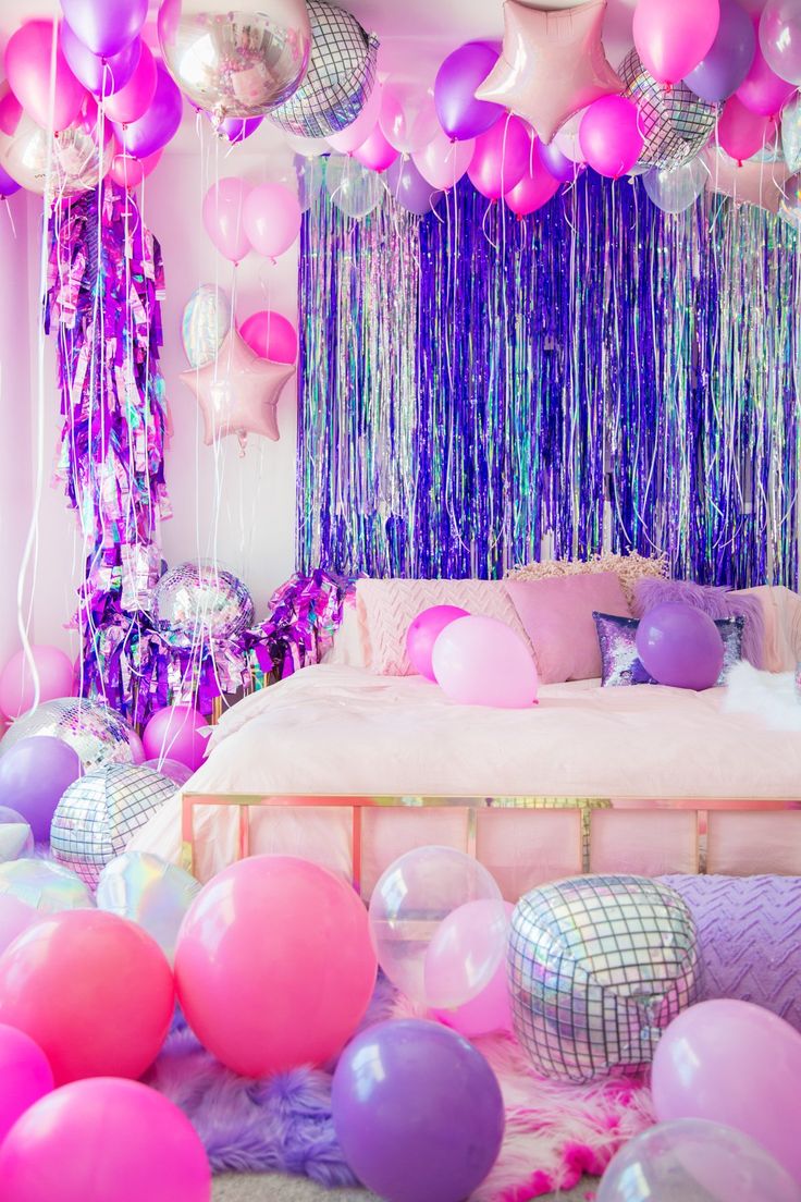 balloons and streamers fill the ceiling in this bedroom