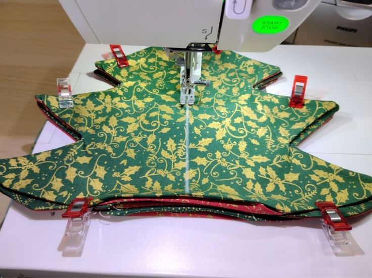 a green and yellow christmas tree pillow on a sewing machine