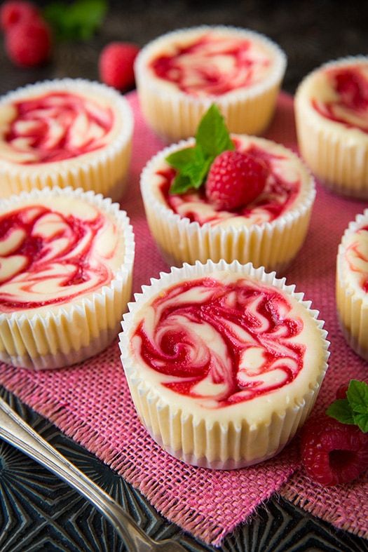 raspberry swirl cheesecakes on a pink cloth