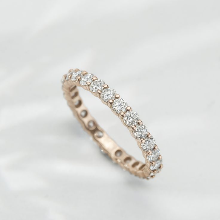 Our take on the eternity band. Each curve of the design was labored over to ensure the diamonds are shown in their fullest light. Luxury Half Eternity Moissanite Band, Luxury Moissanite Half Eternity Band, Vvs Clarity Moissanite Eternity Band, Rose Gold Diamond Eternity Band With Prong Setting, Rose Gold Eternity Band With Brilliant Cut Cubic Zirconia, Timeless Rose Gold Round Cut Eternity Band, Dazzling Half Eternity Band With Round Cut, Rose Gold Eternity Band With Brilliant Cut, Dazzling Moissanite Half Eternity Band