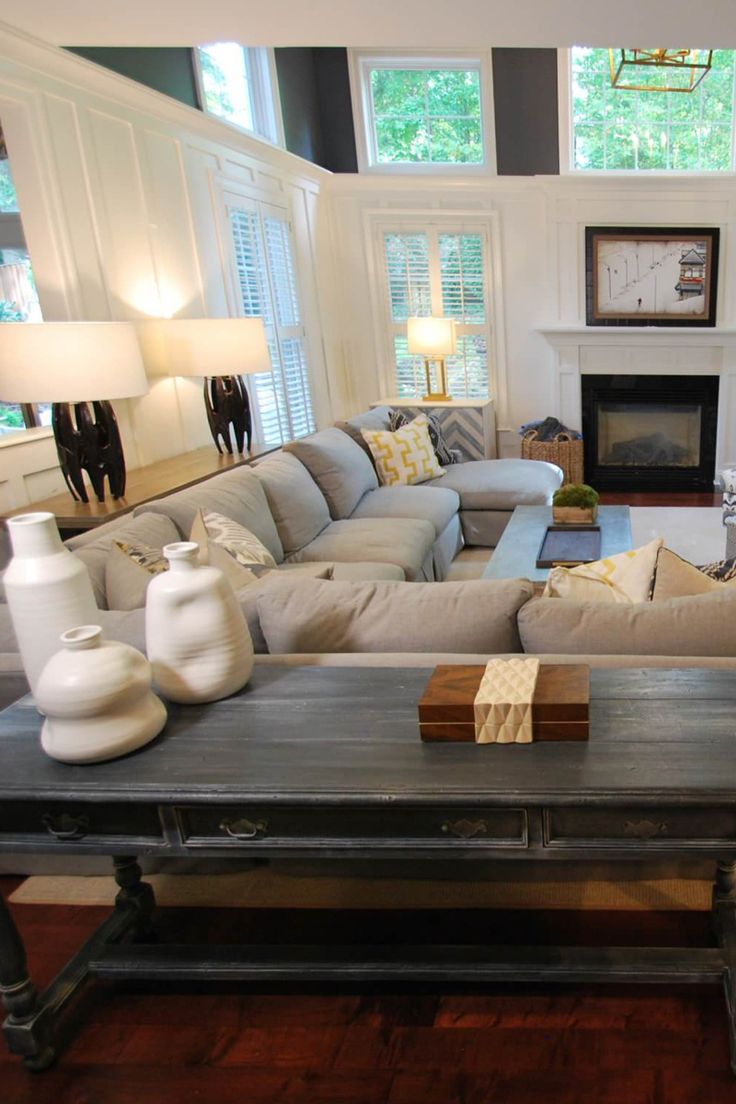 a living room filled with furniture and a fire place in the middle of a room