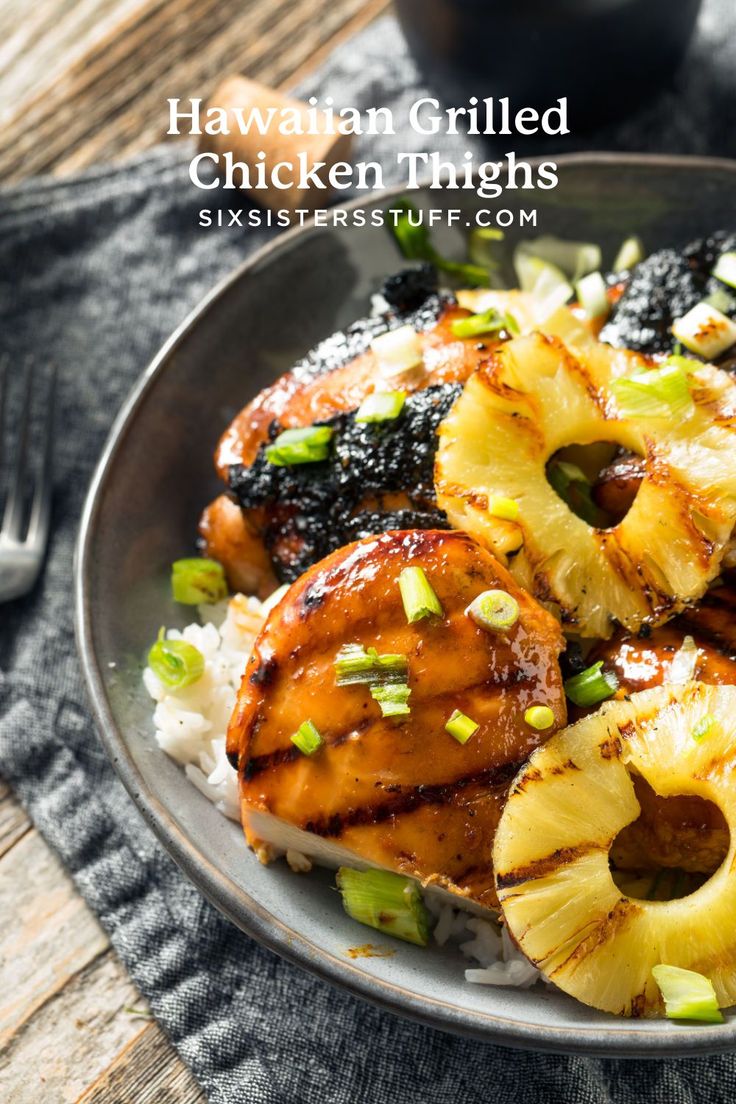 a plate with chicken, pineapples and rice on it next to a fork