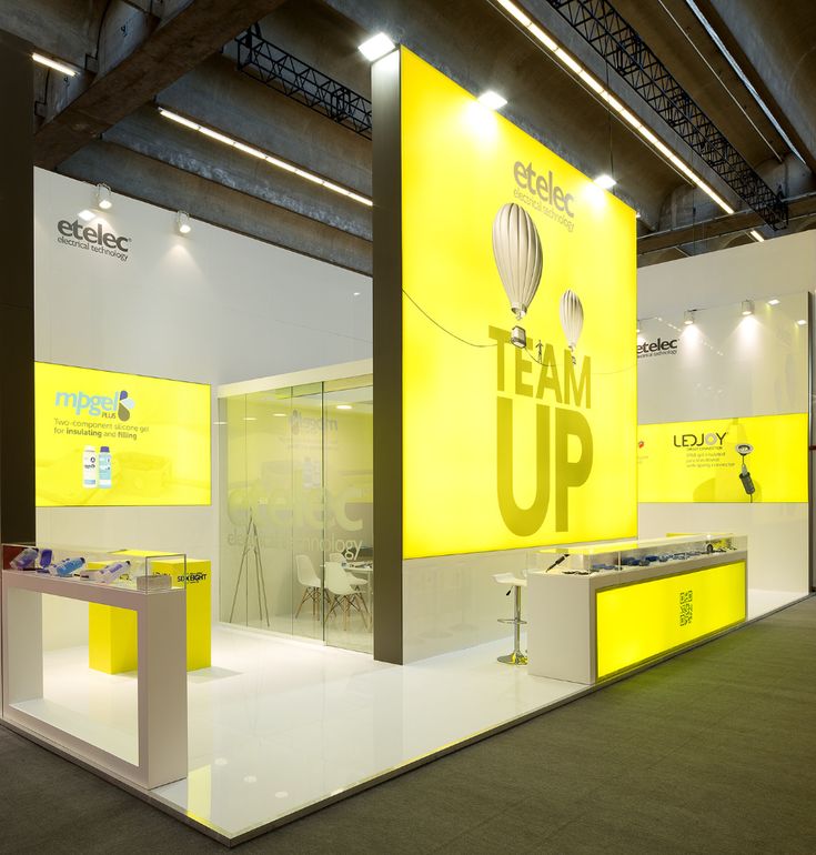 an exhibition stand with yellow and white walls