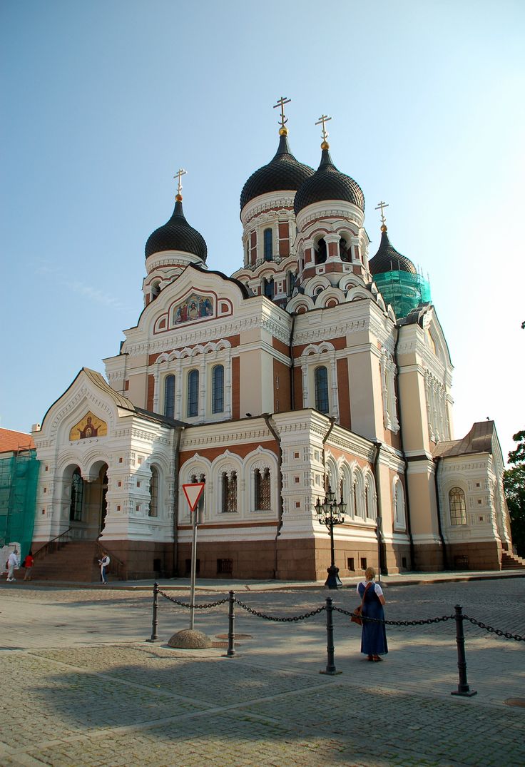 a large white and brown building with two towers