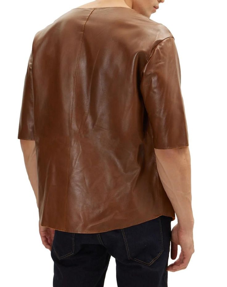 Looking for a way to upgrade your style with a touch of luxury? Look no further than our Brown Leather T Shirt! This luxurious tee is made from premium sheepskin leather and features a soft, supple texture that feels amazing against the skin. The polyester lining ensures ultimate comfort, so you can wear it all day long. Our Brown Leather T Shirt is versatile enough to be dressed up or down. Pair it with jeans and sneakers for a casual look, or dress it up with a pair of slacks and dress shoes f Brown Leather Casual Tops, Casual Brown Leather Tops, Casual Brown Leather Top, Casual Leather Short Sleeve Tops, Casual Leather Tops With Short Sleeves, Casual Leather Top With Short Sleeves, Casual Short Sleeve Leather Top, Modern Leather Tops For Workwear, Brown Leather Top For Fall