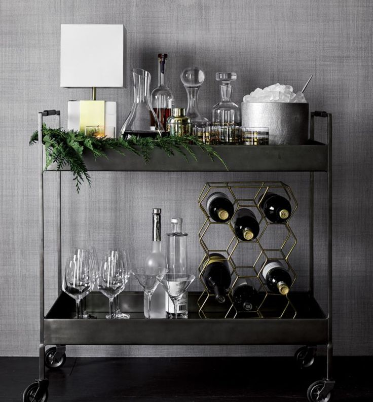 a bar cart filled with glasses and bottles