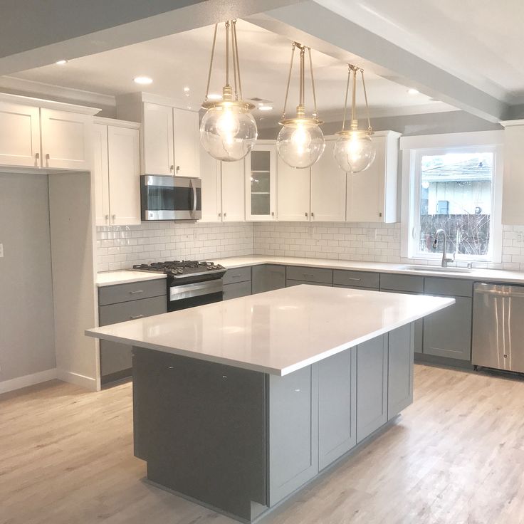 a kitchen with an island, stove and refrigerator