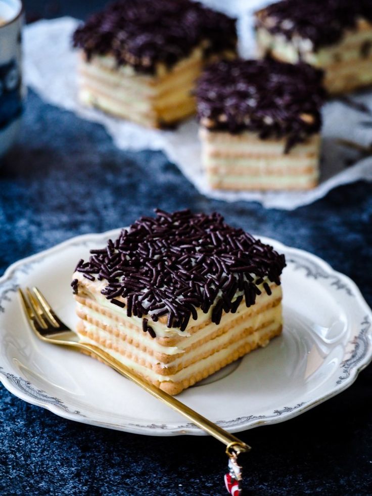 a piece of cake with chocolate sprinkles on it sitting on a plate