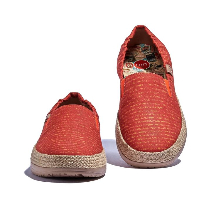 a pair of red shoes with white soles