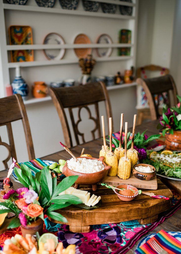 a wooden table topped with plates and bowls filled with different types of food on top of it