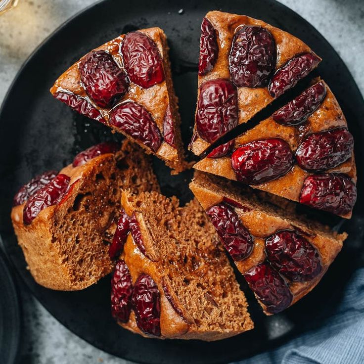 a cake with cherries cut into slices on a plate