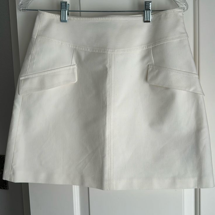 Zara Mini Skirt Lying Flat Measures Hip To Hip 14” Across And Hem To Hem 17” Long. Pockets Are Detail Only With Zippered Side Closure. Chic Skirted Skort With Pockets, High Waist White Mini Skirt For Work, Chic White Skirt With Pockets, White Relaxed Skort With Pockets, White Mini Skort For Workwear, White Skort For Spring Workwear, White Short Skirt For Work, White Mini Skirt With Pockets For Work, Chic White Mini Skirt With Pockets