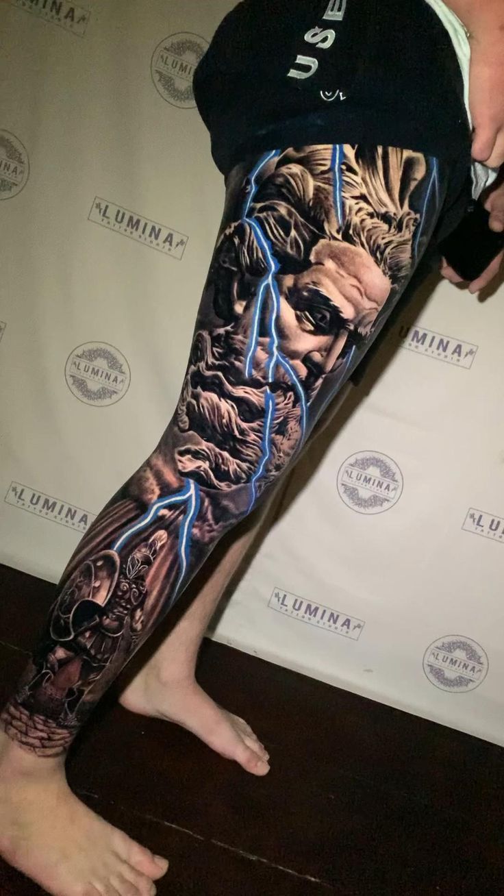 a man's leg with an image of a lion and lightning bolt on it