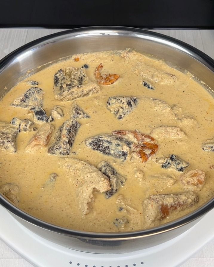 a pan filled with food sitting on top of a stove