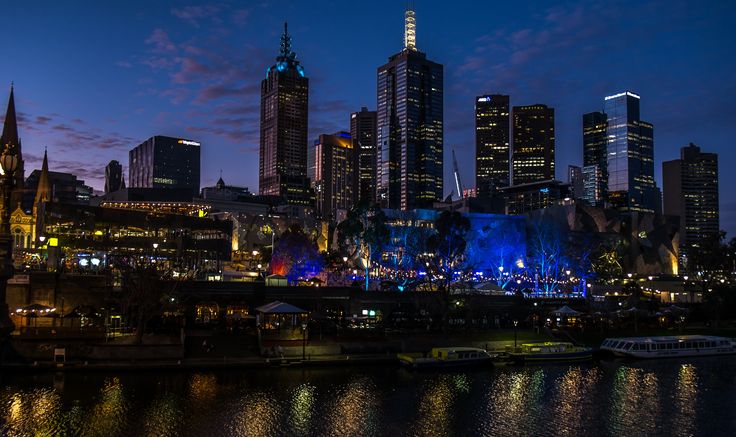 the city skyline is lit up at night