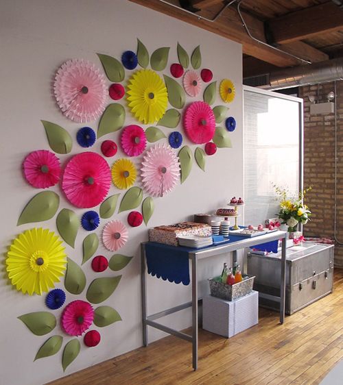 the wall is decorated with colorful paper flowers