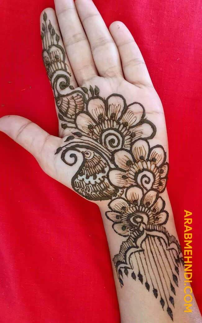 the hand is decorated with henna and flowers