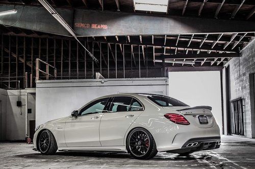 a white car parked in an empty garage