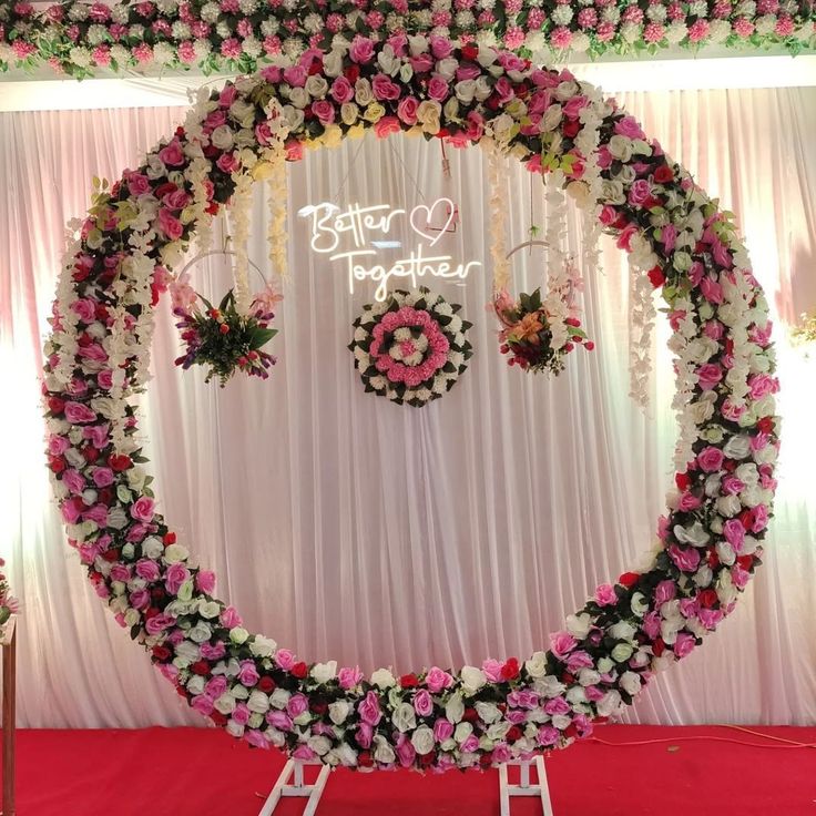 a decorated stage with pink and white flowers