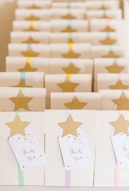 small white bags with gold stars and thank you tags on the front are lined up