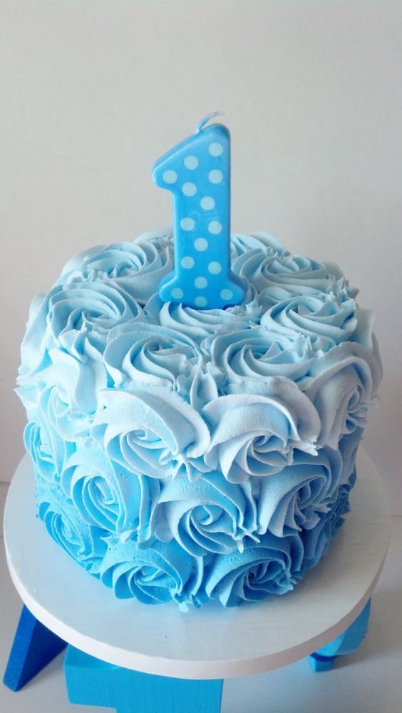 a blue and white cake with a one on top