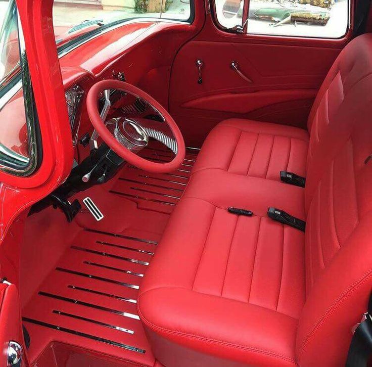 the interior of an old car with red leather seats