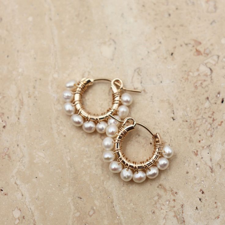 The ideal everyday accessory. These earrings are exceptionally lightweight and designed for a casual, laid-back style. Adorned with lustrous freshwater pearls, they effortlessly blend a touch of elegance with everyday charm. In comparison to our classic Audrey's Pearls, these are the mini version, making them the perfect choice for versatile, go-to earrings. 14 K Gold fill 13 mm. hoops Freshwater Pearls Everyday Pearl White Pearl Earrings, Everyday Hypoallergenic Pearl White Pearl Earrings, Everyday Round Pearl Chain Earrings, Everyday Pearl Charm Hoop Earrings, Everyday Small Hoop Pearl Chain Jewelry, Dainty Everyday Pearl Earrings, Classic Pearl Earrings With Pearl Chain For Everyday, Minimalist Pearl Earrings For Everyday Elegance, Minimalist Pearl Earrings For Everyday