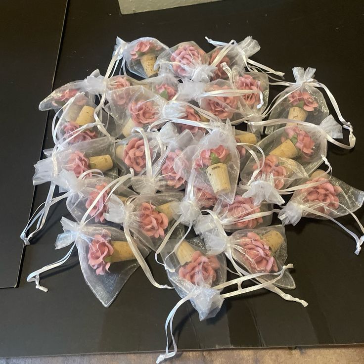 some pink and white cookies wrapped in clear bags