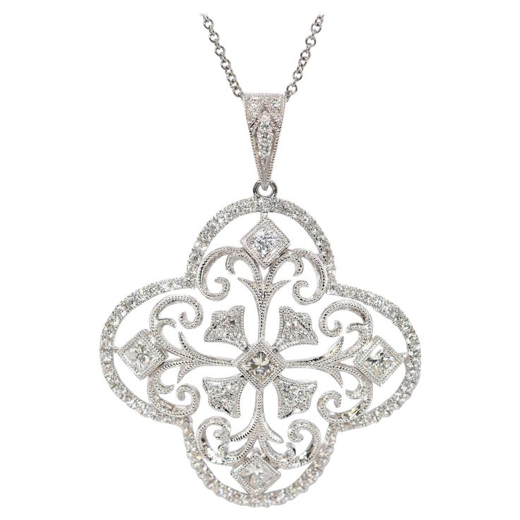 This pendant is made in 18k white gold, and it features round diamond set into a flower-style pendant. The diamonds have a total weight of 1.20cttw and they are graded G-H in color and VS-SI in clarity. The pendant measures 31mm in diameter, and it slides along an 18-inch 14k white gold chain. The necklace weighs 7.7 grams. Luxury Silver Diamond Necklace In Flower Shape, Luxury Silver Flower-shaped Diamond Necklace, Silver Diamond Necklace With Flower Design, Silver Diamond Necklace With Flower Accents, White Gold Diamond Necklace With Flower Shape Accents, Diamond White Necklace With Flower Shaped Diamond Accents, Diamond White Flower-shaped Necklace With Diamond Accents, Flower-shaped Diamond Necklace With Single Cut Diamonds, Flower Shaped Diamond Necklace With Single Cut Diamonds