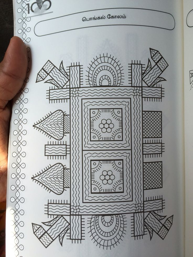 a hand holding an open coloring book with designs on the pages and in the middle