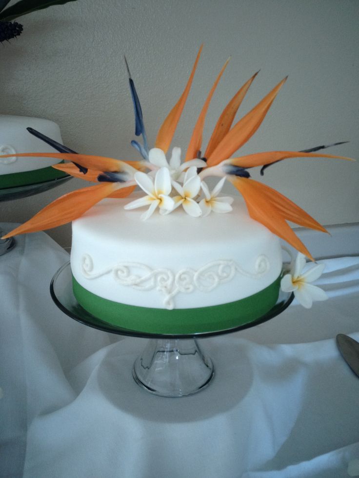 there is a white cake with orange flowers on it