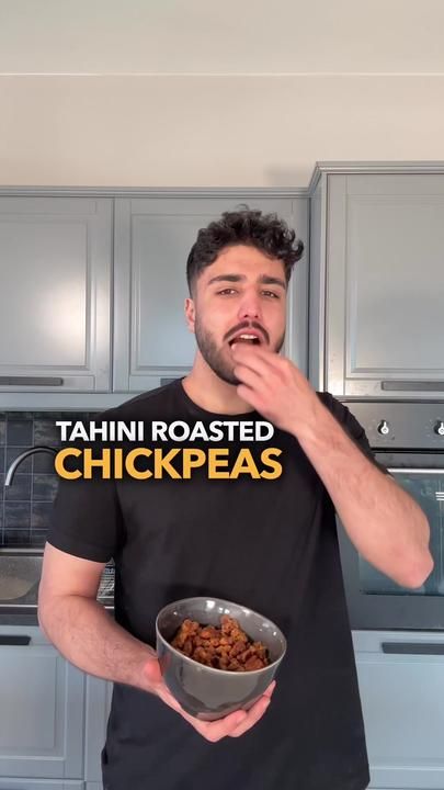 a man holding a bowl of food with the words tahn roasted chickpeas