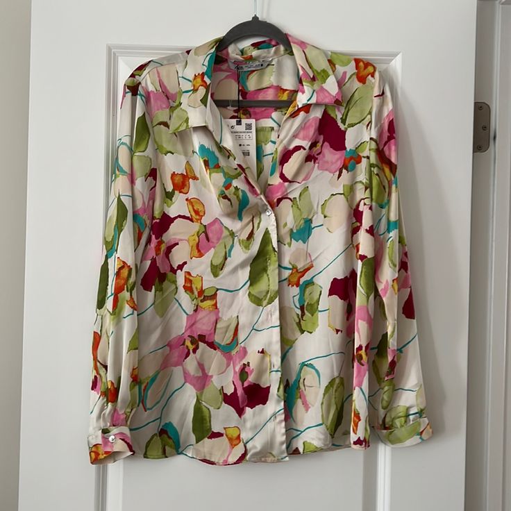 This Beautiful Blouse Can Go From Day To Night In A Snap. It’s Soft And Silky Material Is Very Flattering. It’s Brand New With Tags And Ready For A New Home. Elegant Pink Shirt With Floral Print, Elegant Pink Floral Print Shirt, Printed Pink V-neck Shirt, Pink Silk Blouse For Spring, Pink Feminine V-neck Shirt, Chic Pink Floral Print Shirt, Feminine Long Sleeve Multicolor Blouse, Feminine Pink Floral Print Shirt, Feminine Multicolor Long Sleeve Blouse