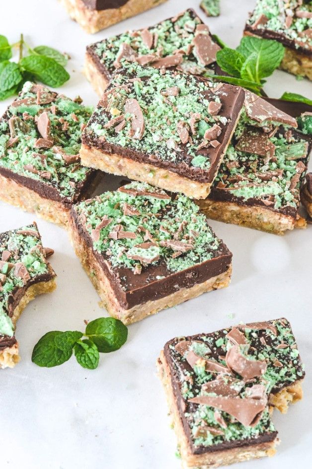 several pieces of chocolate and mint shortbread on a plate with mint sprinkles