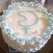 a cake with white frosting and blue swirls on it sitting on a table