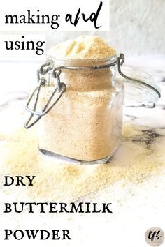 a jar filled with dry buttermik sitting on top of a counter next to the words making and using dry buttermilk powder