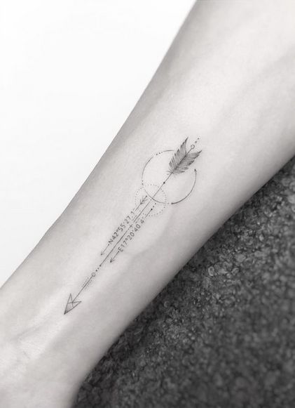 a woman's arm with an arrow and quote tattoo on the left inner forearm