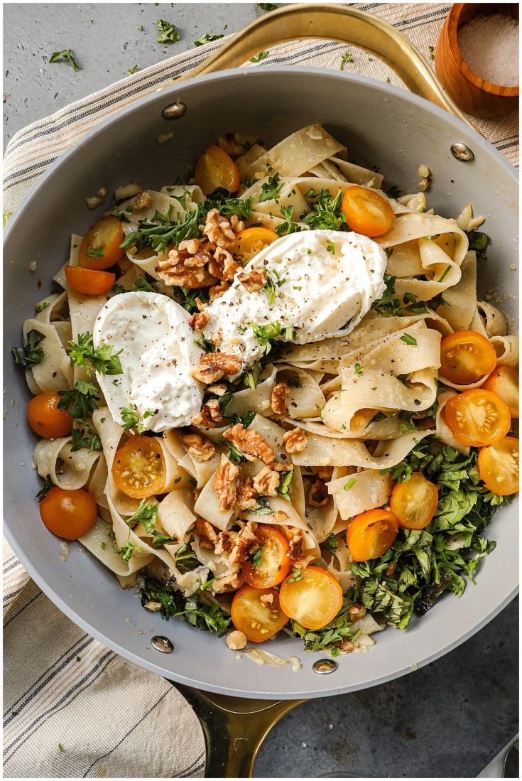 a bowl filled with pasta and vegetables on top of a table