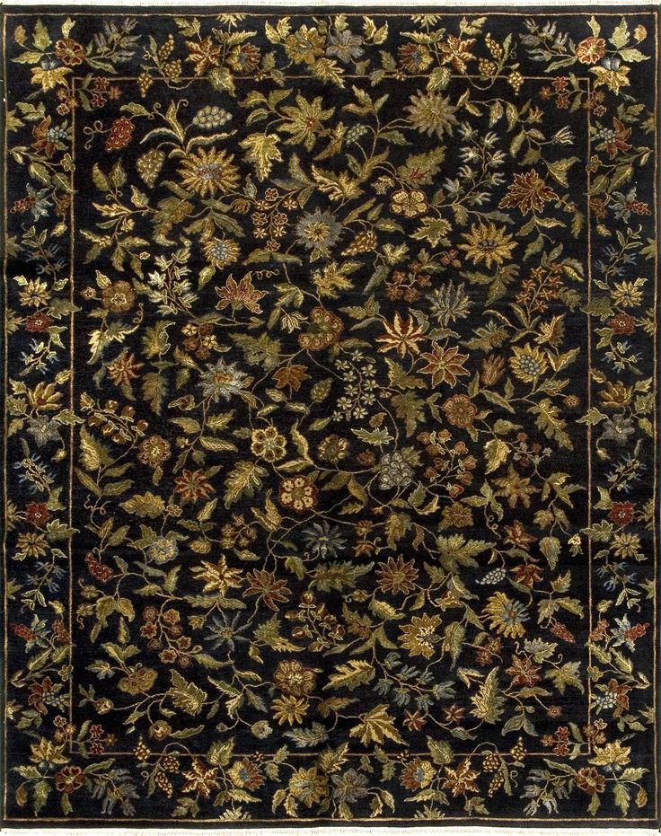 a black rug with flowers and leaves on the bottom, in an ornate frame around it