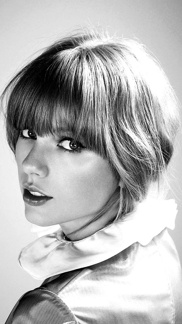 a black and white photo of a woman with short hair wearing a collared shirt