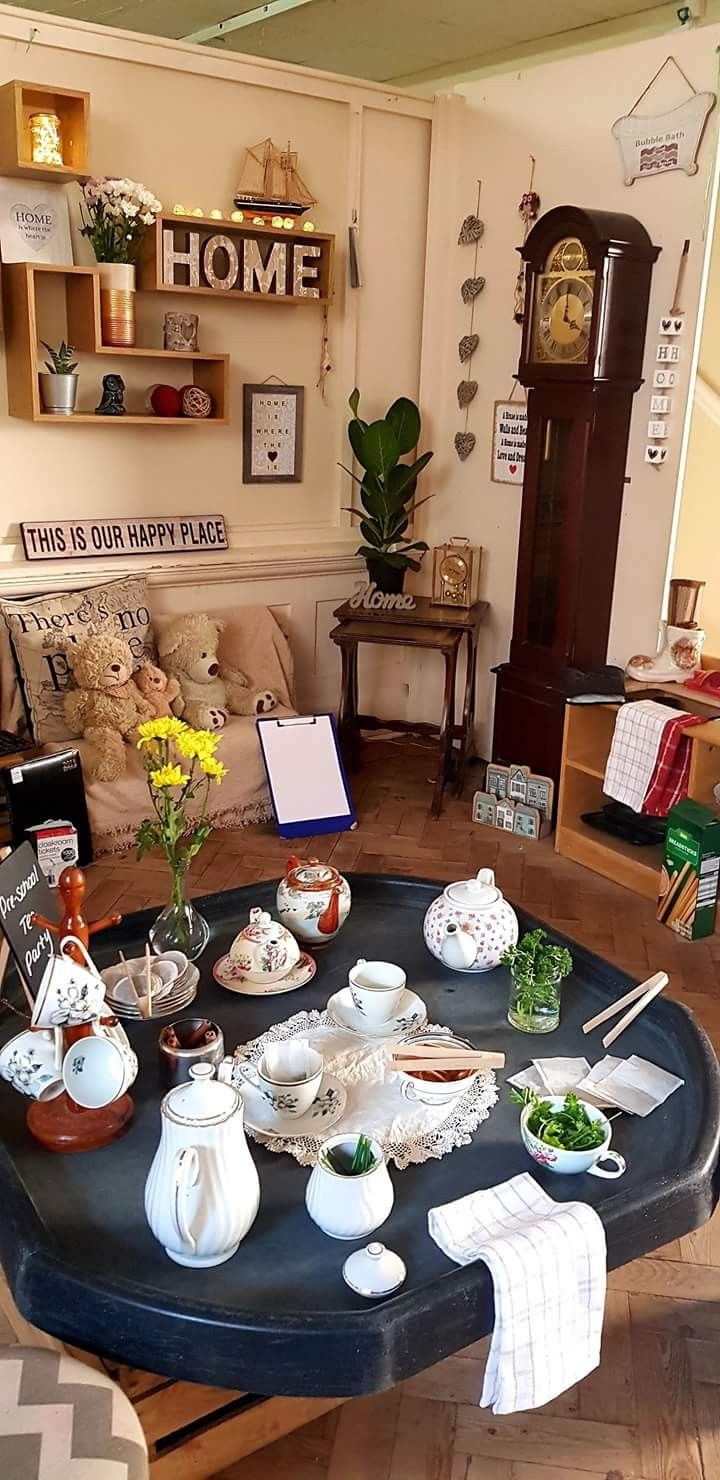 a living room filled with furniture and lots of clutter on top of a table