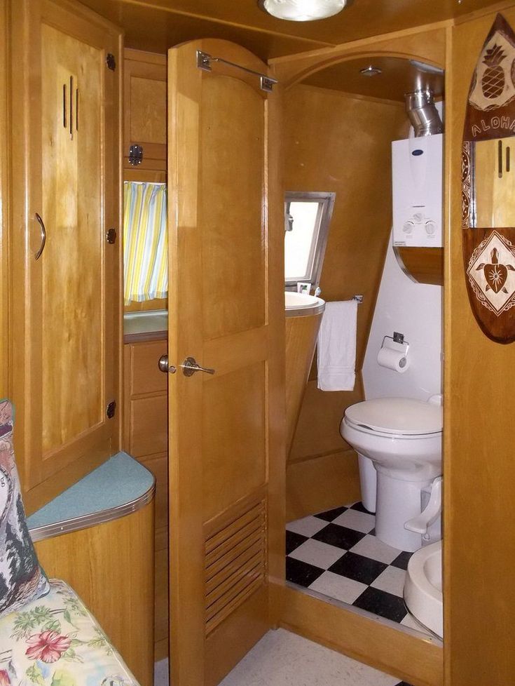 the inside of a small bathroom with a toilet and sink