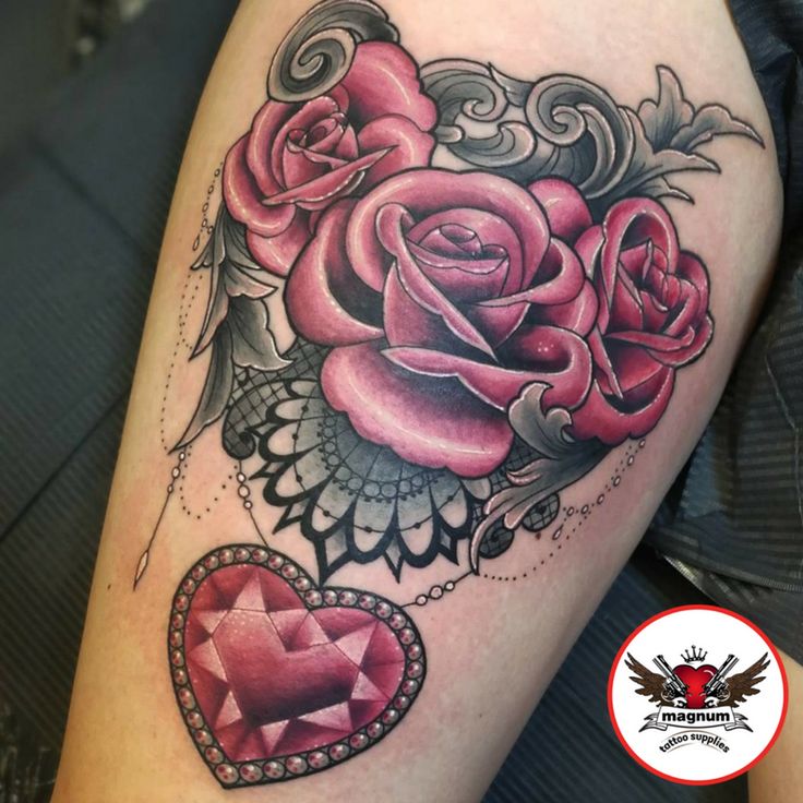 a woman's thigh with roses and a heart tattoo on her left calf area