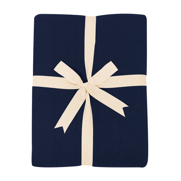 a blue and white blanket with a bow on it's side, folded in two rows