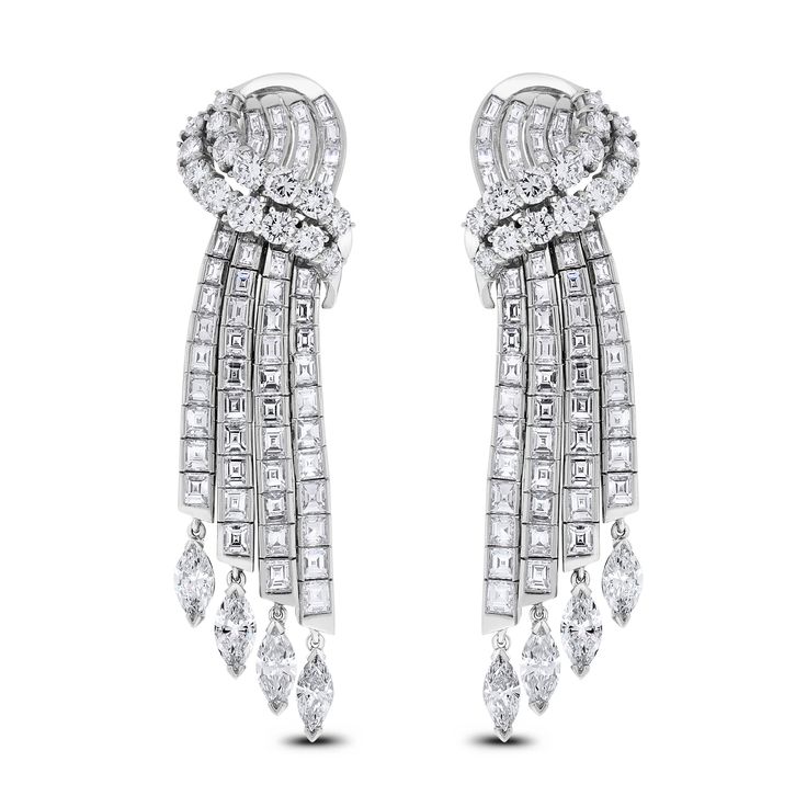 These classic channel set earrings exude luxury and extravagance. The are an ideal family heirloom or present for an important occasion. Diamond Shape: Round, Baguette & Marquise Total Diamond Weight: 14.75 ct Diamonds Color: G - H Diamonds Clarity: VVS - VS (Very Very Slightly Included - Very Slightly Included) Metal: 18K White Gold Metal Wt: 31.95 gms Setting: Prong & Channel Set Length: 2.4 Inches (6.10 cms) Omega Back Closure Diamond Waterfall Earrings, White Gold Heart Necklace, Unique Diamond Earrings, Heart Diamond Earrings, Classic Channel, Ideal Family, Pearl Chandelier Earrings, Diamond Chandelier Earrings, Diamond Chandelier